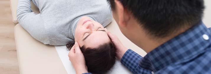 Chiropractor in Springfield VA Kenneth Kim Gently Adjusting Patient Chiropractor in Springfield VA Kenneth Kim Gently Adjusting Patient